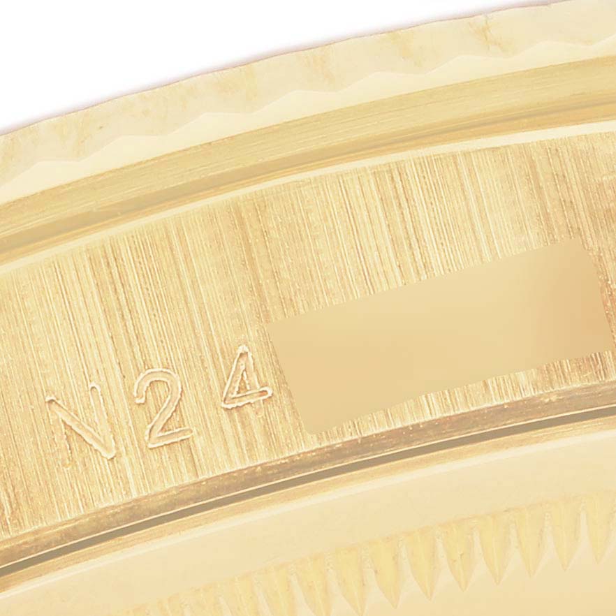 This is a close-up shot of the model/serial number engraving on the bezel of a Rolex President 18338 Men's Yellow Gold Mother of Pearl Dial 18338 Men's Yellow Gold Mother of Pearl Dial watch.