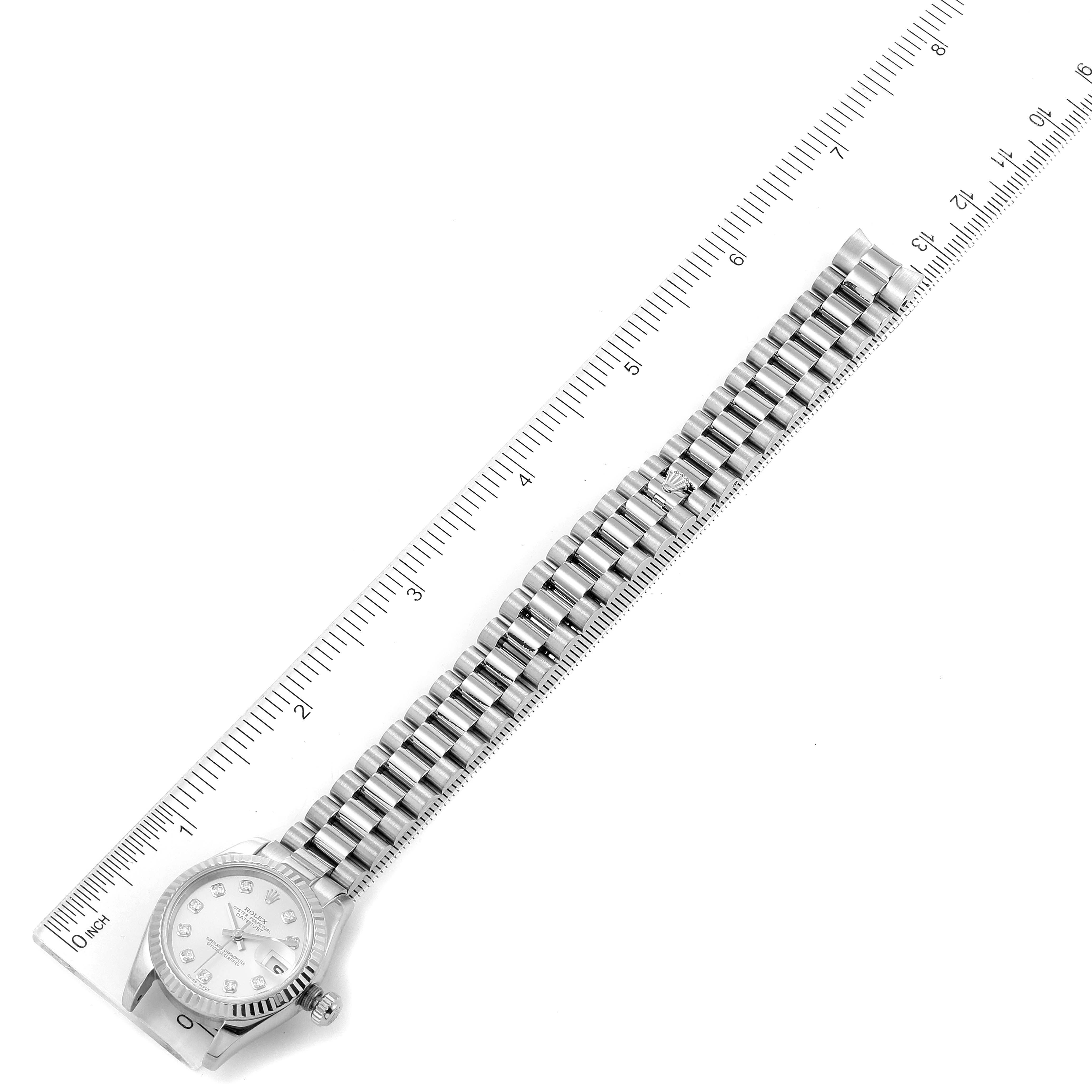 This image shows a top-down view of the Rolex President 179179 Women's White Gold Silver Dial 179179 Women's White Gold Silver Dial watch, including the face, bezel, and full bracelet, measured against a ruler.
