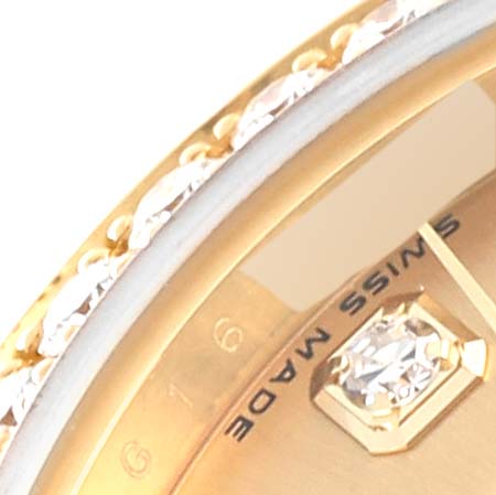 This close-up image of a Rolex President 179138 Women's Yellow Gold Champagne Dial 179138 Women's Yellow Gold Champagne Dial model shows part of the dial with diamond accents and the "Swiss Made" marking.