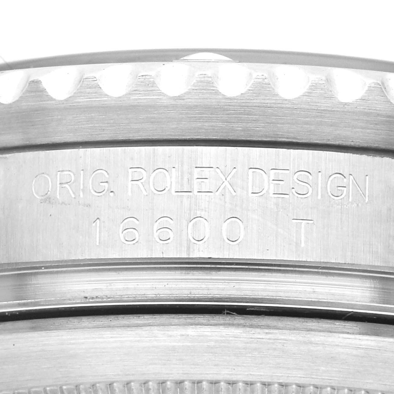 The image shows a close-up of the side of a Rolex Sea-Dweller 16600 Men
s Stainless Steel Black Dial 16600 Men
s Stainless Steel Black Dial watch, revealing the model number 16600 T and inscription "ORIG. ROLEX DESIGN".
