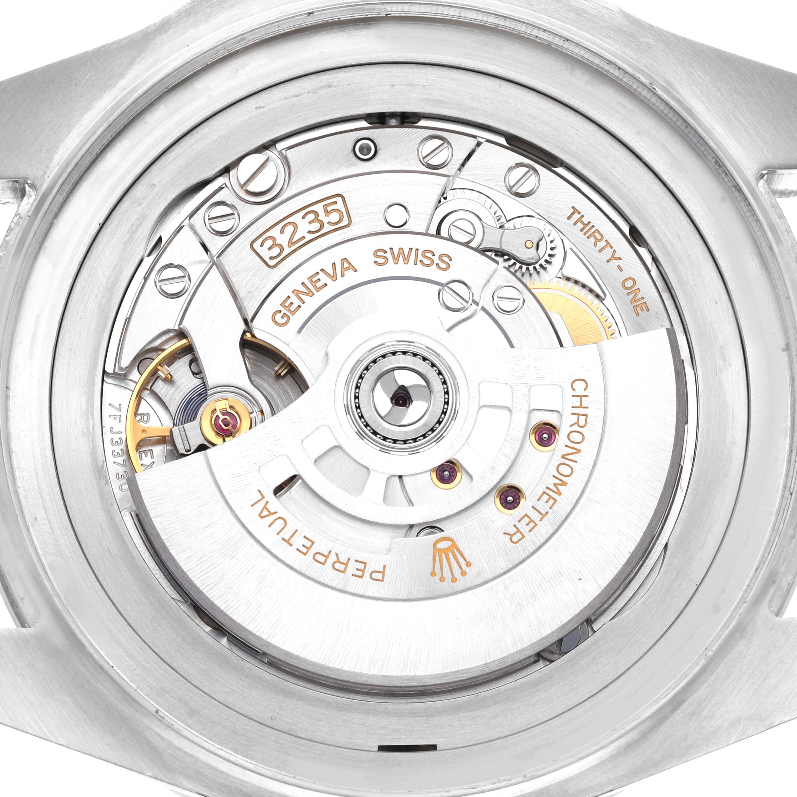 The image shows the Rolex Sea-Dweller 136660 Men
s Stainless Steel Blue Dial
s movement from the back, highlighting gears, the rotor, and engravings.