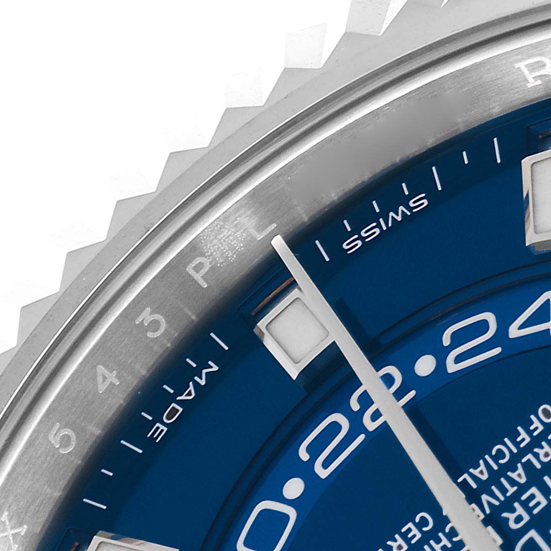 The image shows a close-up of the face, bezel, and part of the dial of the Rolex Sky-Dweller 326934 Men's Stainless Steel Blue Dial 326934 Men's Stainless Steel Blue Dial watch at an angle.