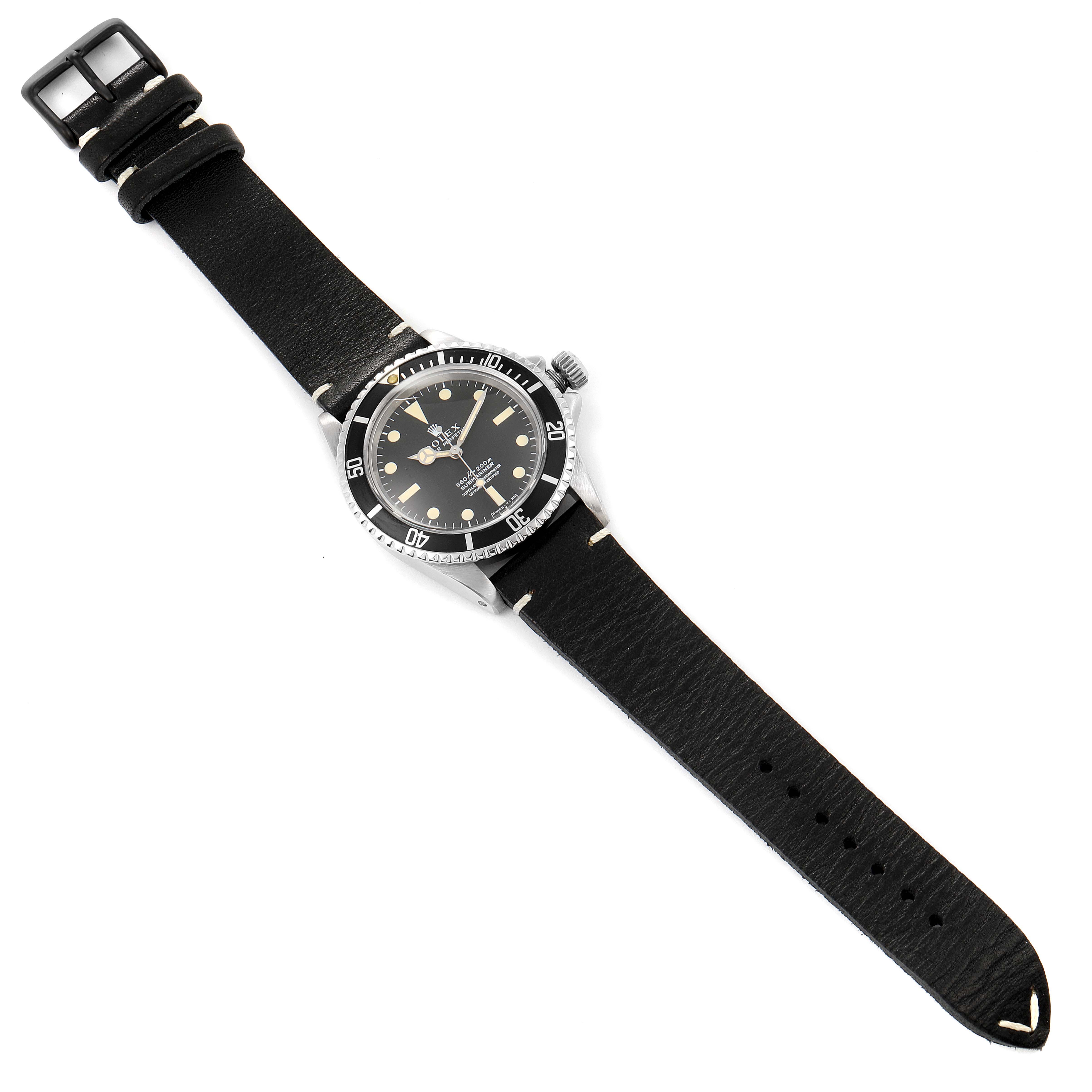 The image shows a vintage Rolex Collection watch from a top-down angle, highlighting the face, bezel, crown, and leather strap.