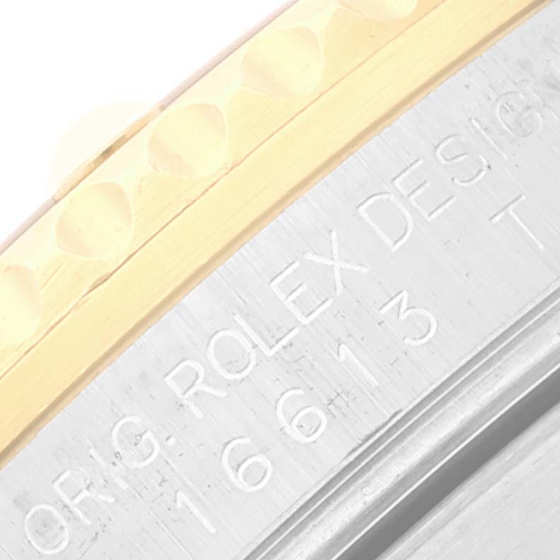 This image shows a close-up of the side of the Rolex Submariner 16613 Men
s Stainless Steel Blue Dial 16613 Men
s Stainless Steel Blue Dial watch, focusing on the serial engraving on the case and part of the bezel.