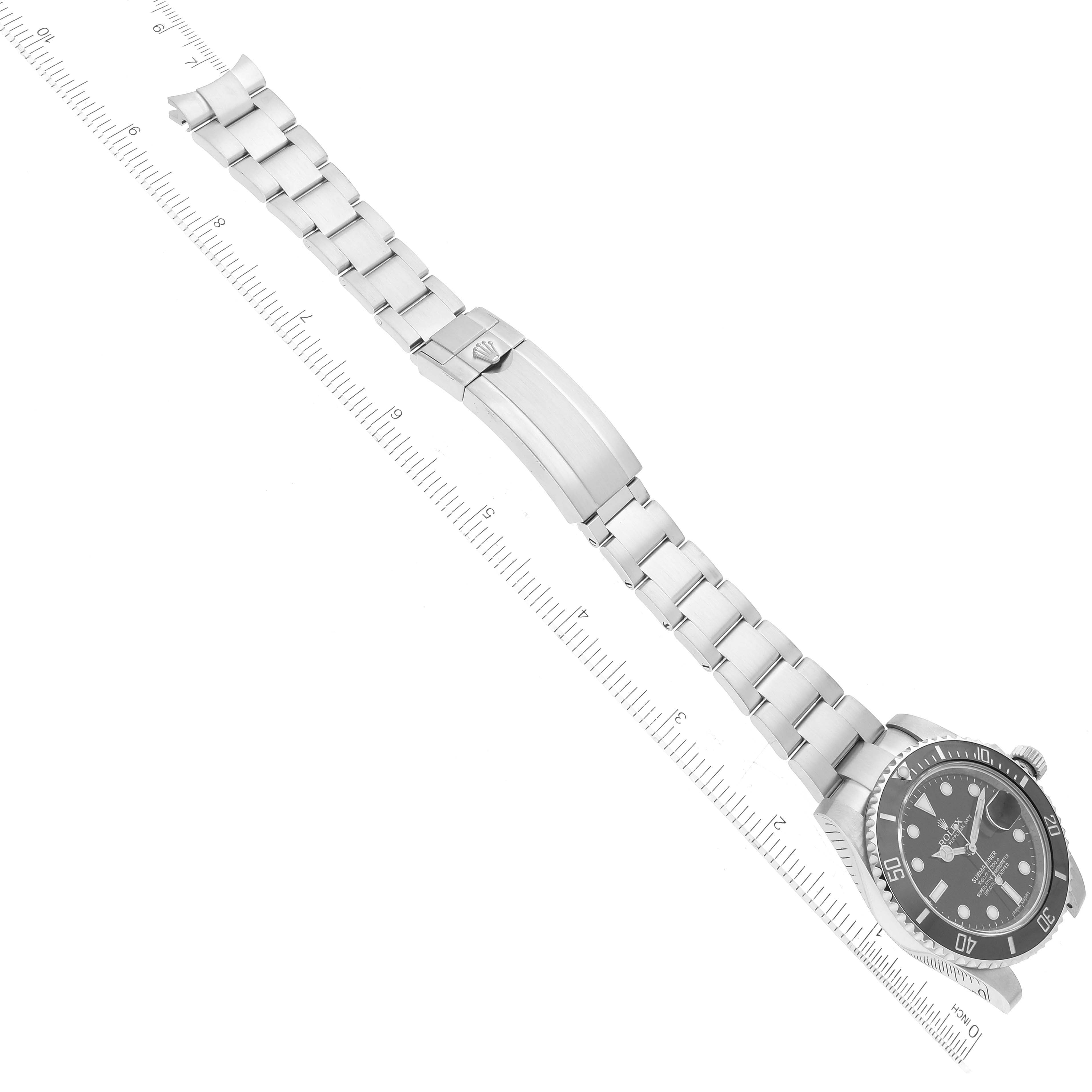 The image shows a Rolex Submariner 116610 Men
s Stainless Steel Black Dial 116610 Men
s Stainless Steel Black Dial watch laid flat, emphasizing the face and the full length of its metal bracelet with a clasp.