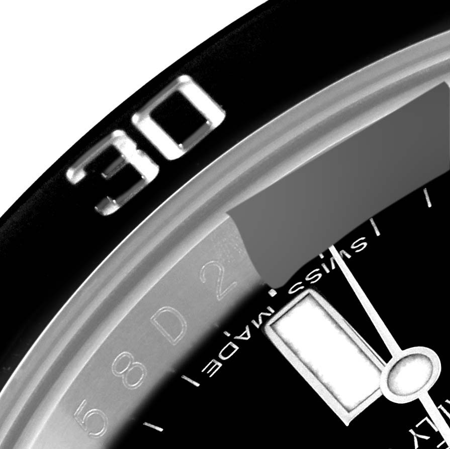 This image shows a close-up angle of the Rolex Submariner 116610 Men
s Stainless Steel Black Dial 116610 Men
s Stainless Steel Black Dial bezel, dial, and part of the minute hand.
