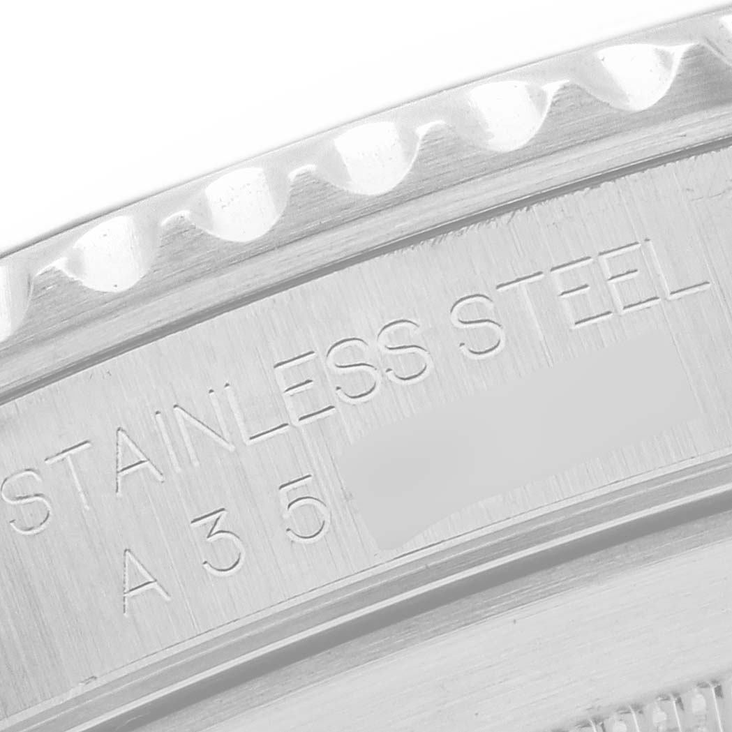 This image shows a close-up of the edge of the stainless steel case back of a Rolex Submariner 14060 Men
s Stainless Steel Black Dial 14060 Men
s Stainless Steel Black Dial watch.