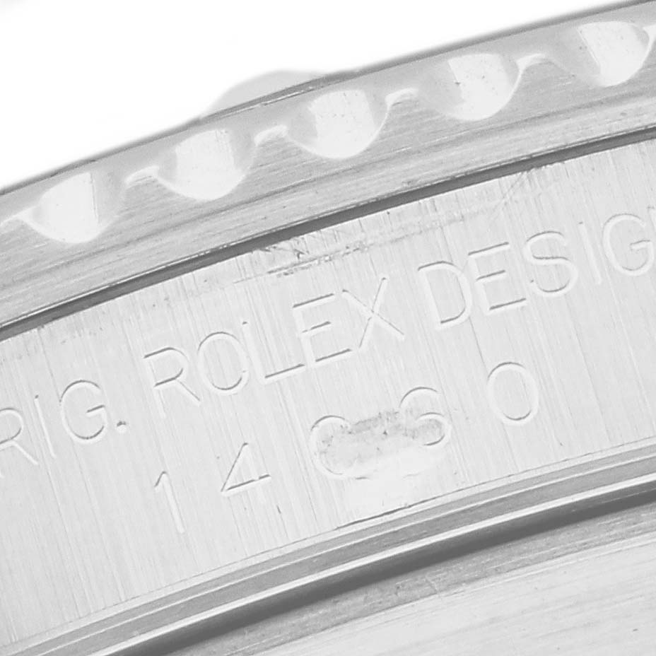 This close-up image shows the engraved serial and model numbers on the case back of a Rolex Submariner 14060 Men
s Stainless Steel Black Dial 14060 Men
s Stainless Steel Black Dial watch.