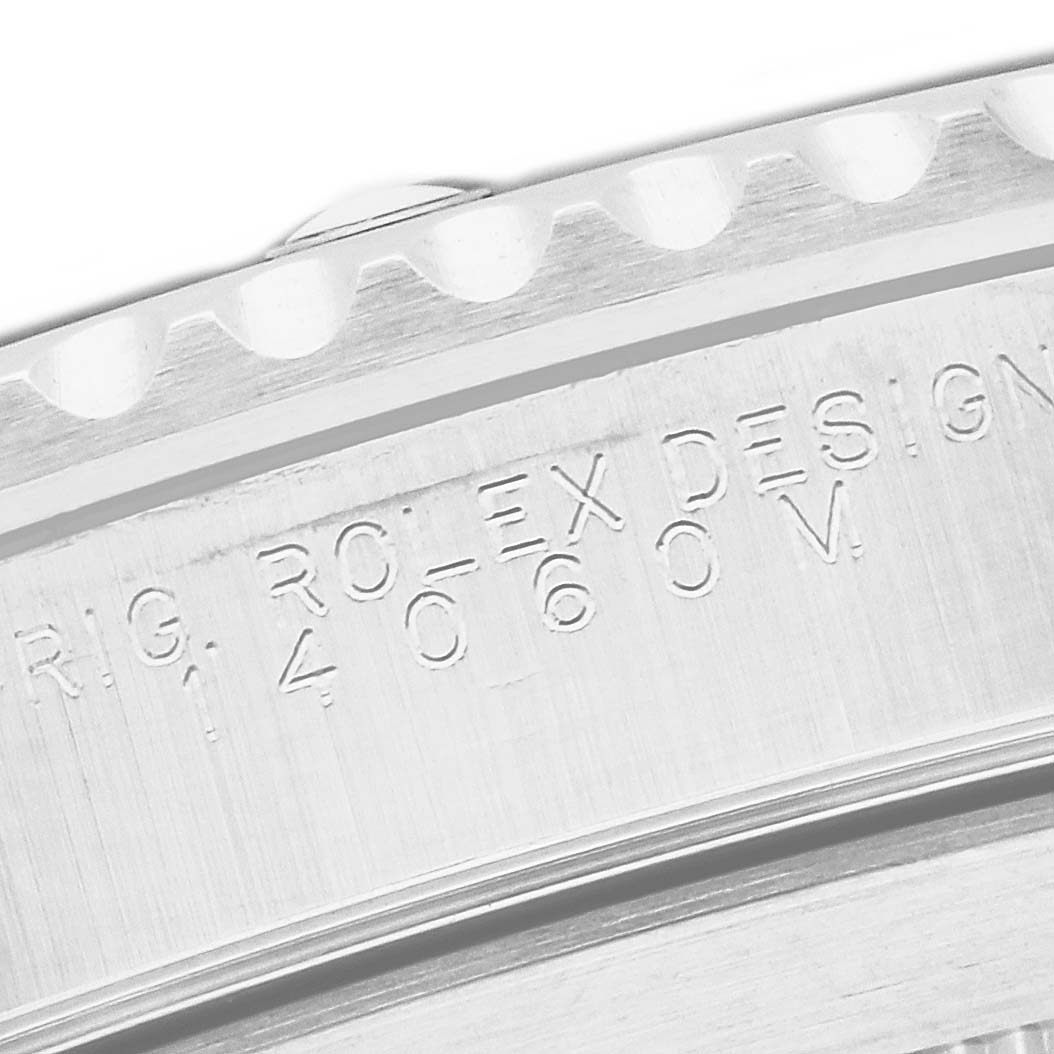 This image shows a close-up of the case back and etched serial number of a Rolex Submariner 14060M Men
s Stainless Steel Black Dial 14060M Men
s Stainless Steel Black Dial watch.