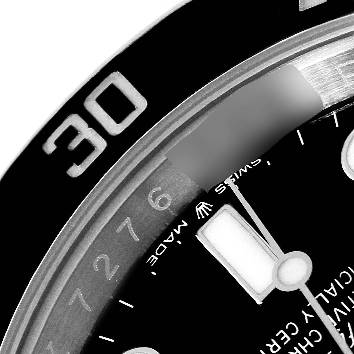 This close-up image shows the 30-minute mark on the bezel and part of the dial of a Rolex Submariner 124060 Men
s Stainless Steel Black Dial 124060 Men
s Stainless Steel Black Dial watch.