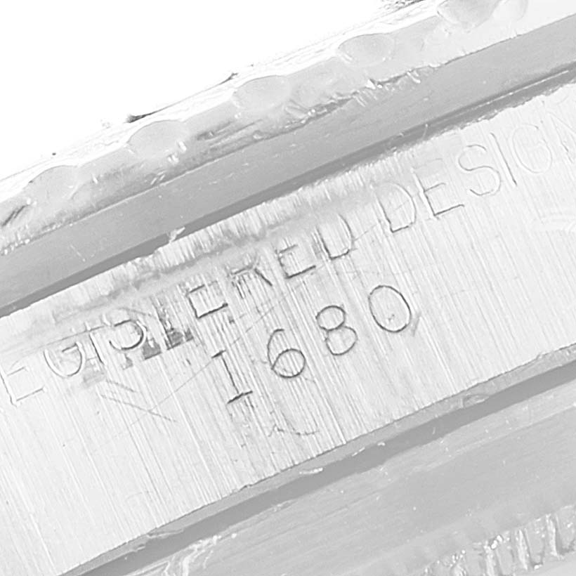 The image shows a close-up of the engraved serial number on the bezel of a Rolex Vintage Collection 1680 Men's Stainless Steel Black Dial 1680 Men's Stainless Steel Black Dial model 1680.