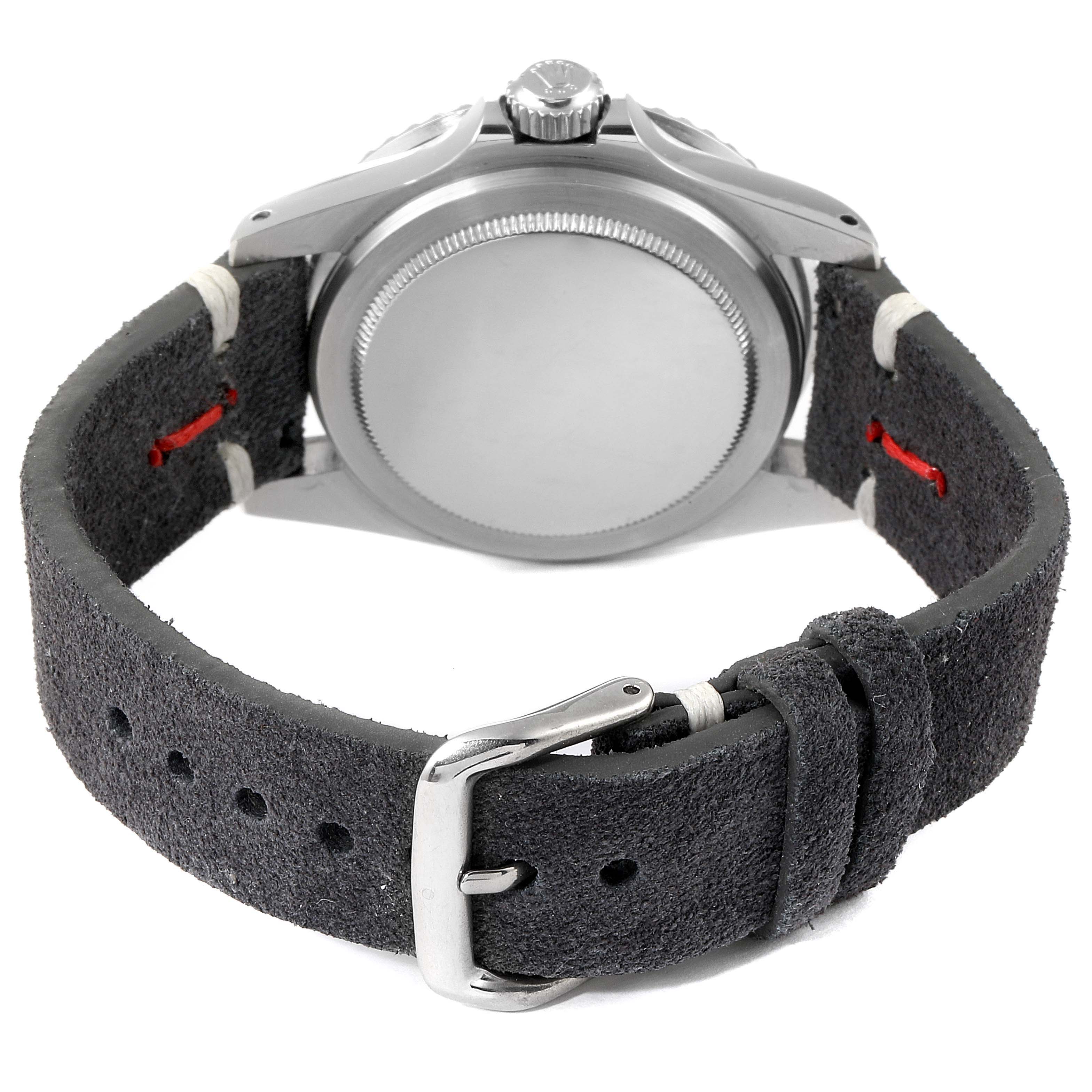 The image shows the back view of a Rolex Vintage Collection 1680 Men's Stainless Steel Black Dial 1680 Men's Stainless Steel Black Dial watch, highlighting the case back and black suede strap with buckle.