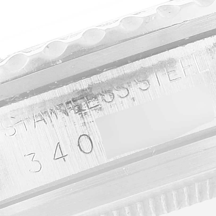 This is a close-up angle of the side of a Rolex Vintage Collection 1680 Men's Stainless Steel Black Dial 1680 Men's Stainless Steel Black Dial watch, showing part of the bezel and the engraved serial number.