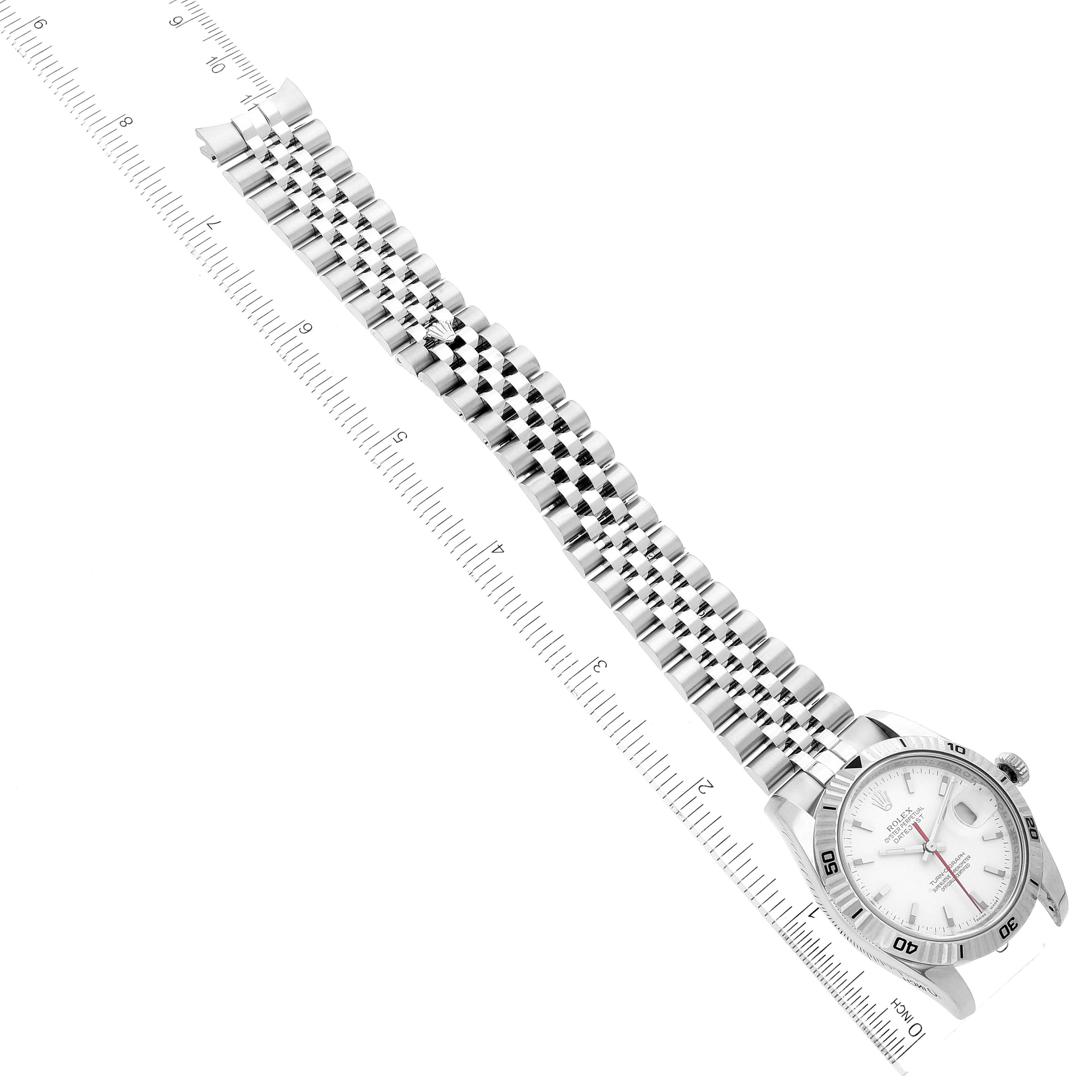 The image shows the Rolex Turn-o-Graph 116264 Men's Stainless Steel White Dial 116264 Men's Stainless Steel White Dial watch at an angle displaying its face, bezel, and full bracelet on a ruler for scale.