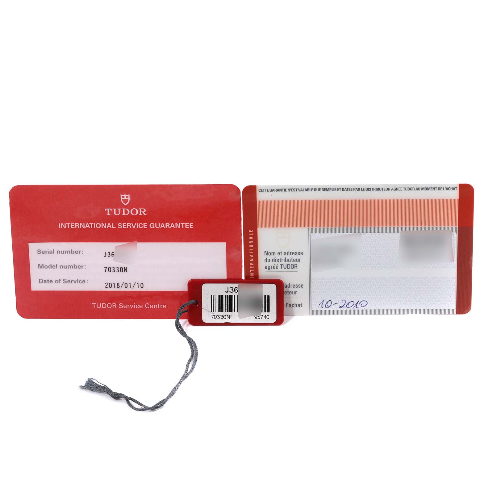 The image shows the Tudor Heritage Chrono 70330N-95740 Men
s Stainless Steel Black Dial 70330N-95740 Men
s Stainless Steel Black Dial model 70330N
s service guarantee cards and a hangtag with the serial number.