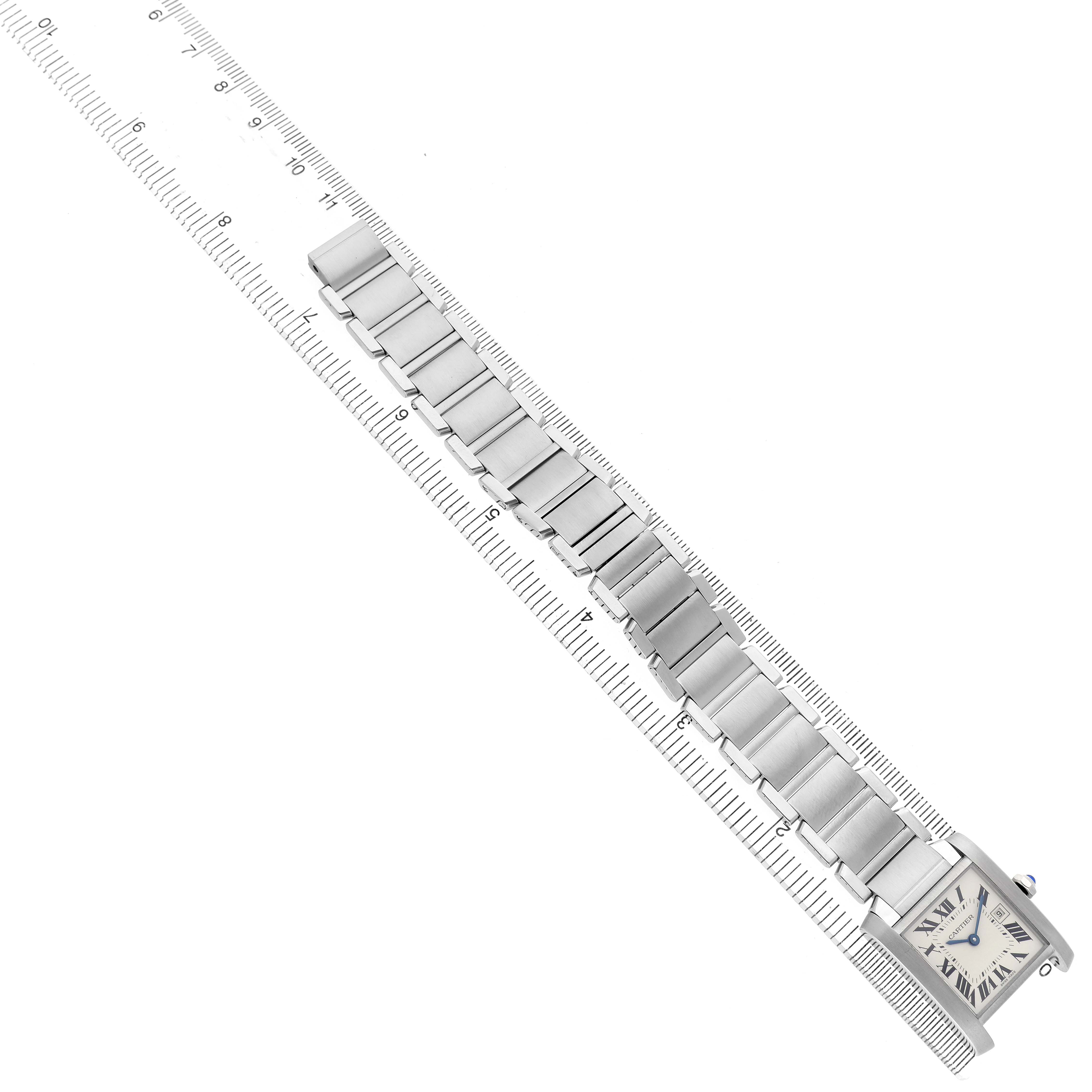 The Cartier Tank Française watch is shown laid flat with a full view of the bracelet and face, aligned on a ruler.