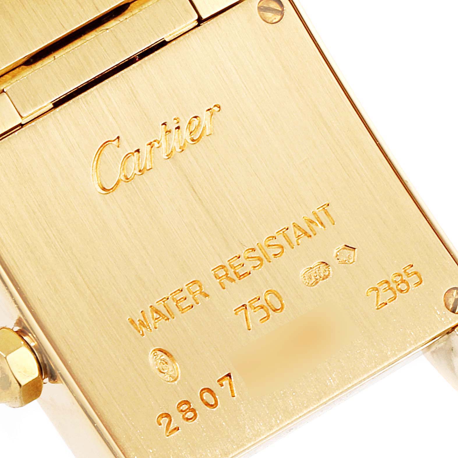 The image shows the back plate of a Cartier Tank Française watch, highlighting inscriptions and hallmark engravings.