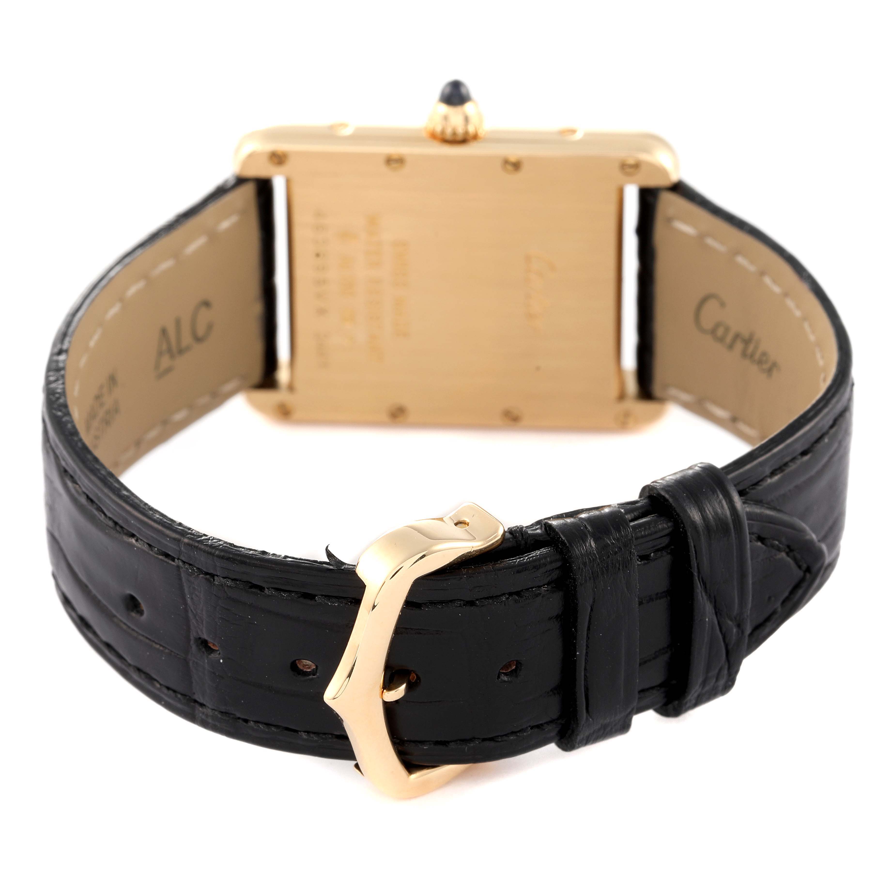The image shows the back view of a Cartier Tank Louis W1529756 Men's Yellow Gold Silver Dial W1529756 Men's Yellow Gold Silver Dial watch, highlighting the case, crown, and black leather strap with a gold buckle.