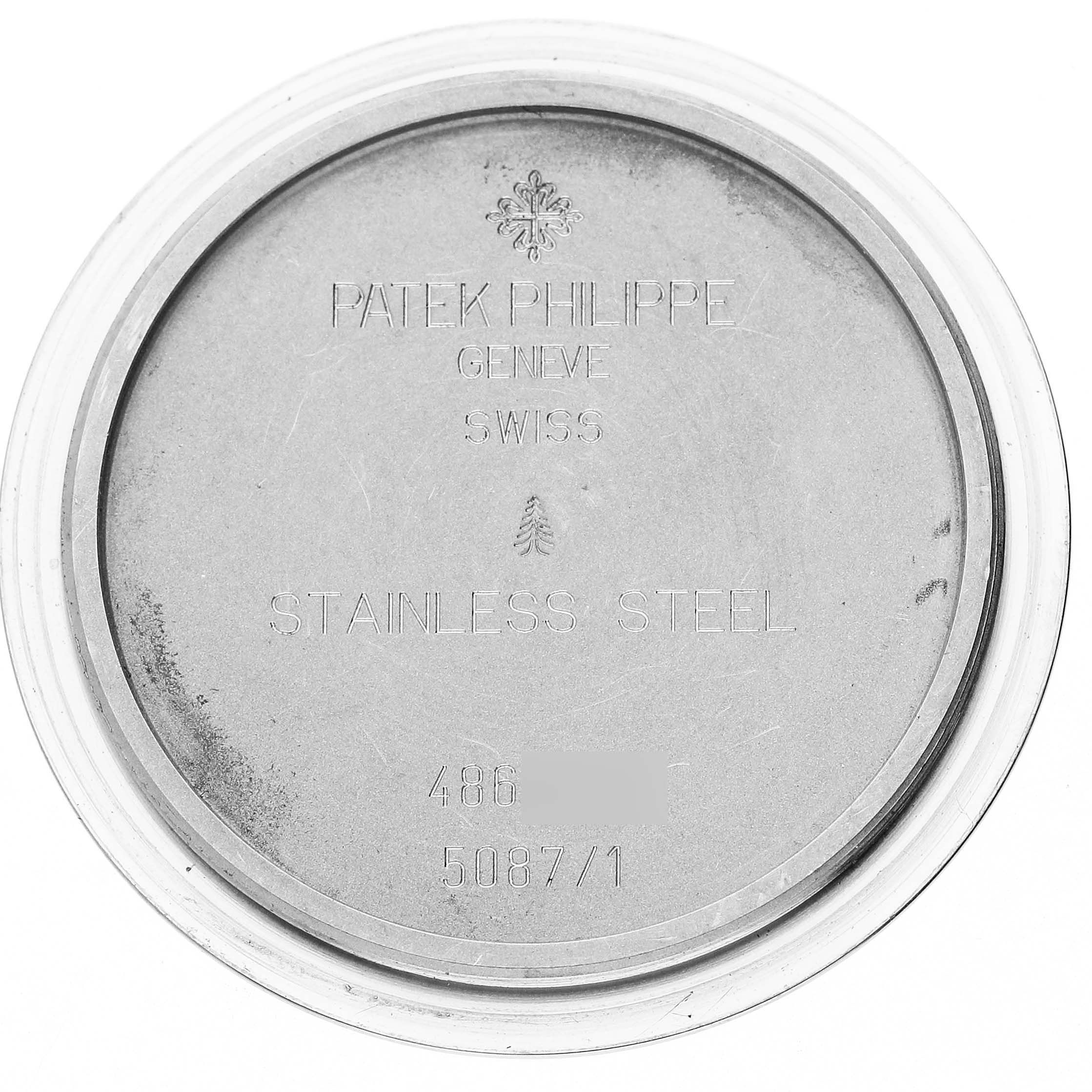 The image shows the back case of a Patek Philippe Aquanaut 5087/1A-001 Women's Stainless Steel Black Dial watch, highlighting the engraving details.