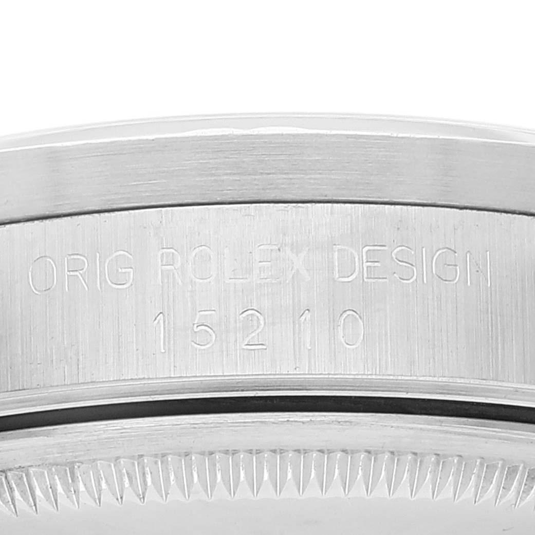 This image shows a close-up of the side of a Rolex Date 15210 Men
s Stainless Steel Silver Dial 15210 Men
s Stainless Steel Silver Dial model watch featuring its case with the model number engraved.