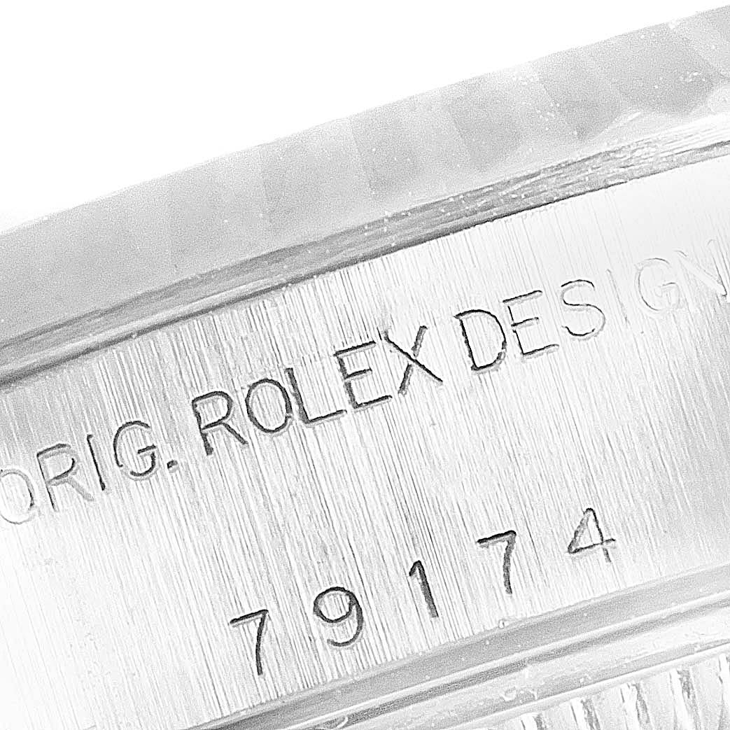 This close-up image captures the side of the bezel of a Rolex Datejust 79174 Women's Stainless Steel Silver Dial 79174 Women's Stainless Steel Silver Dial watch, showing engraved design details and model number.