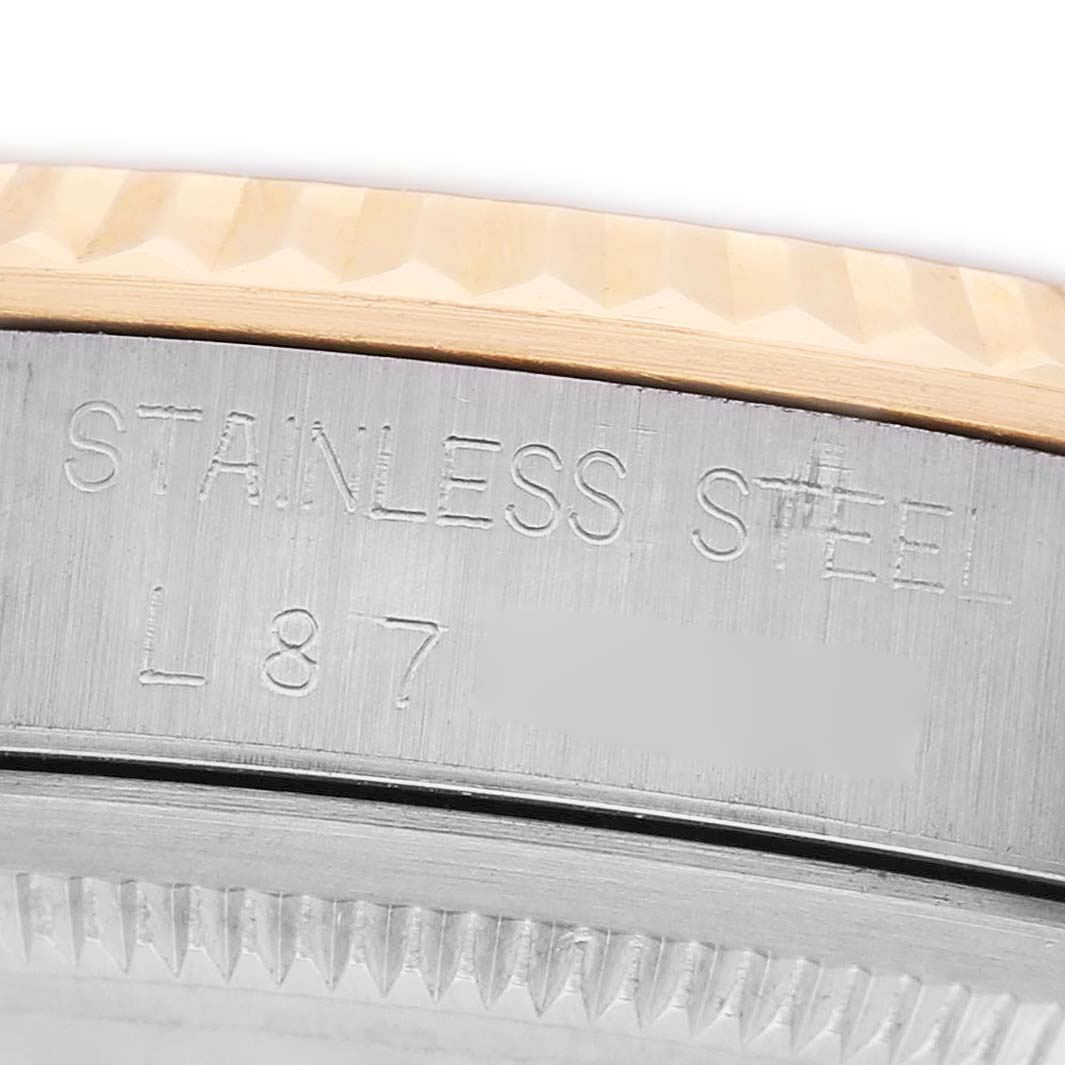 The image shows a close-up of the side of a Rolex Datejust 16233 Men's Steel and Gold (two tone) Silver Dial watch, highlighting the stainless steel case and bezel.