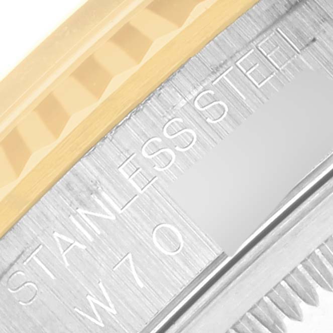 This image shows a close-up of the stainless steel and gold fluted bezel of a Rolex Datejust 16233 Men's Steel and Gold (two tone) Beige Dial 16233 Men's Steel and Gold (two tone) Beige Dial watch.