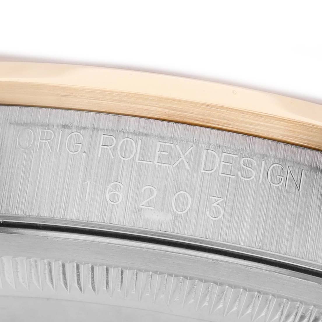 The image shows an angled close-up of the case and serial number engravings on a Rolex Datejust 16203 Men's Steel and Gold (two tone) Silver Dial.