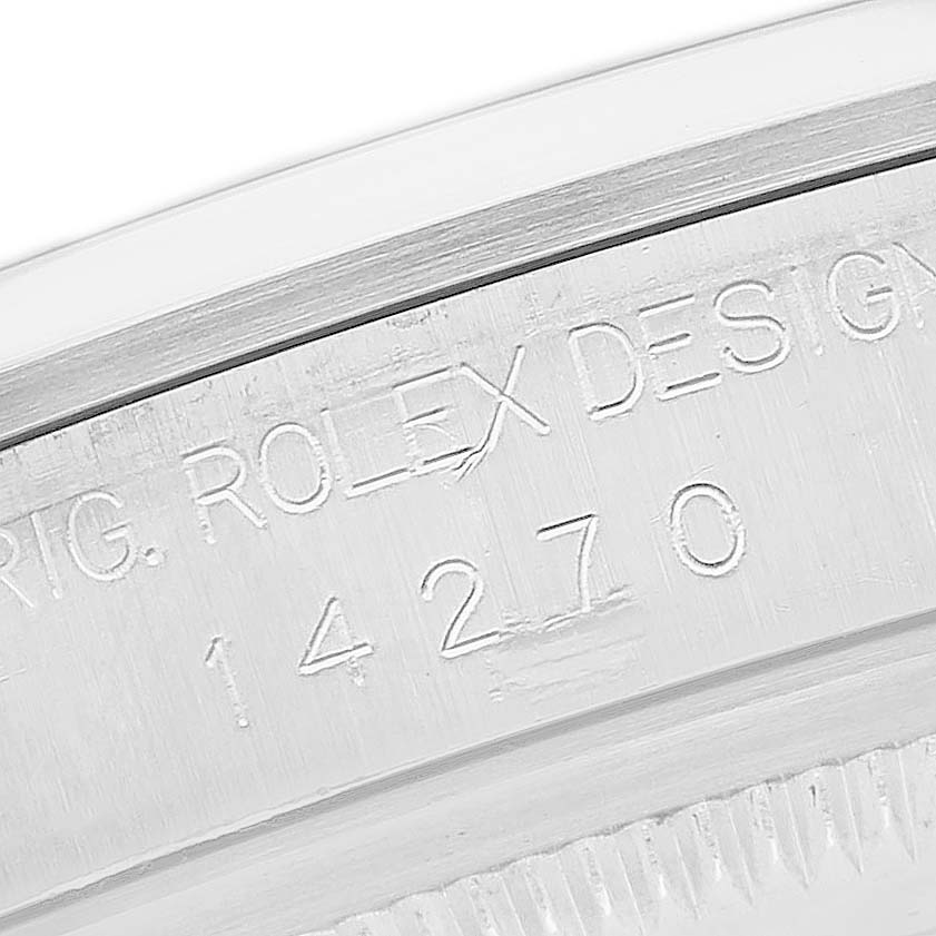 The image shows an angled close-up of the engraved serial number on a Rolex Explorer 14270 Men's Stainless Steel Black Dial's case.