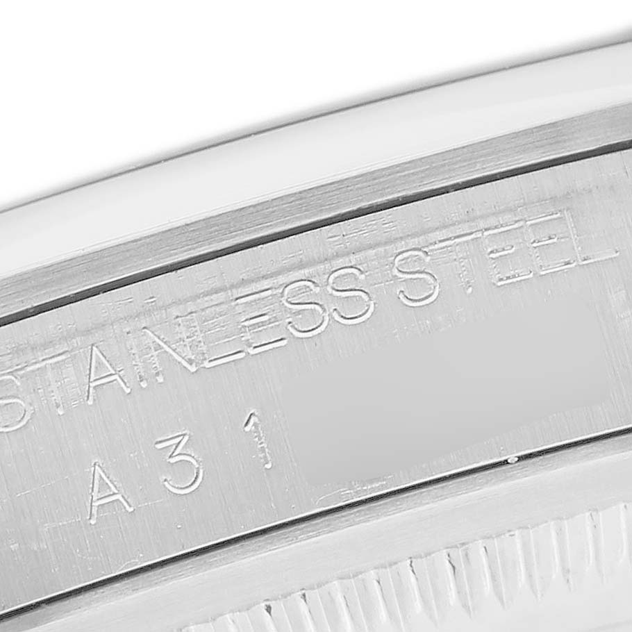 The image shows a detailed view of the bezel and outer rim engraving on a Rolex Explorer 14270 Men's Stainless Steel Black Dial watch, emphasizing "STAINLESS STEEL."