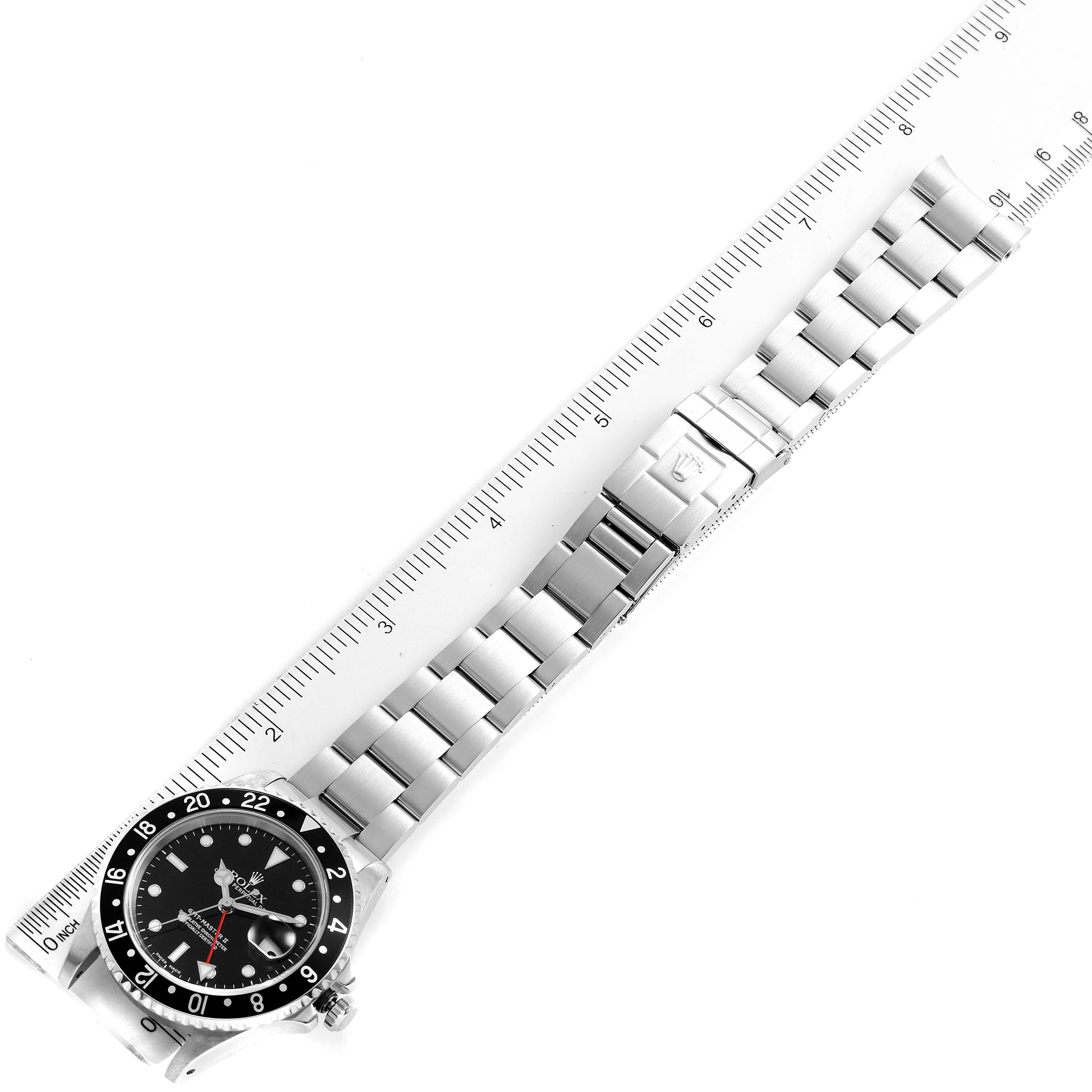 The image shows a Rolex GMT-Master 16710 Men's Stainless Steel Black Dial 16710 Men's Stainless Steel Black Dial watch positioned diagonally with its bracelet laid straight, next to a measurement ruler.
