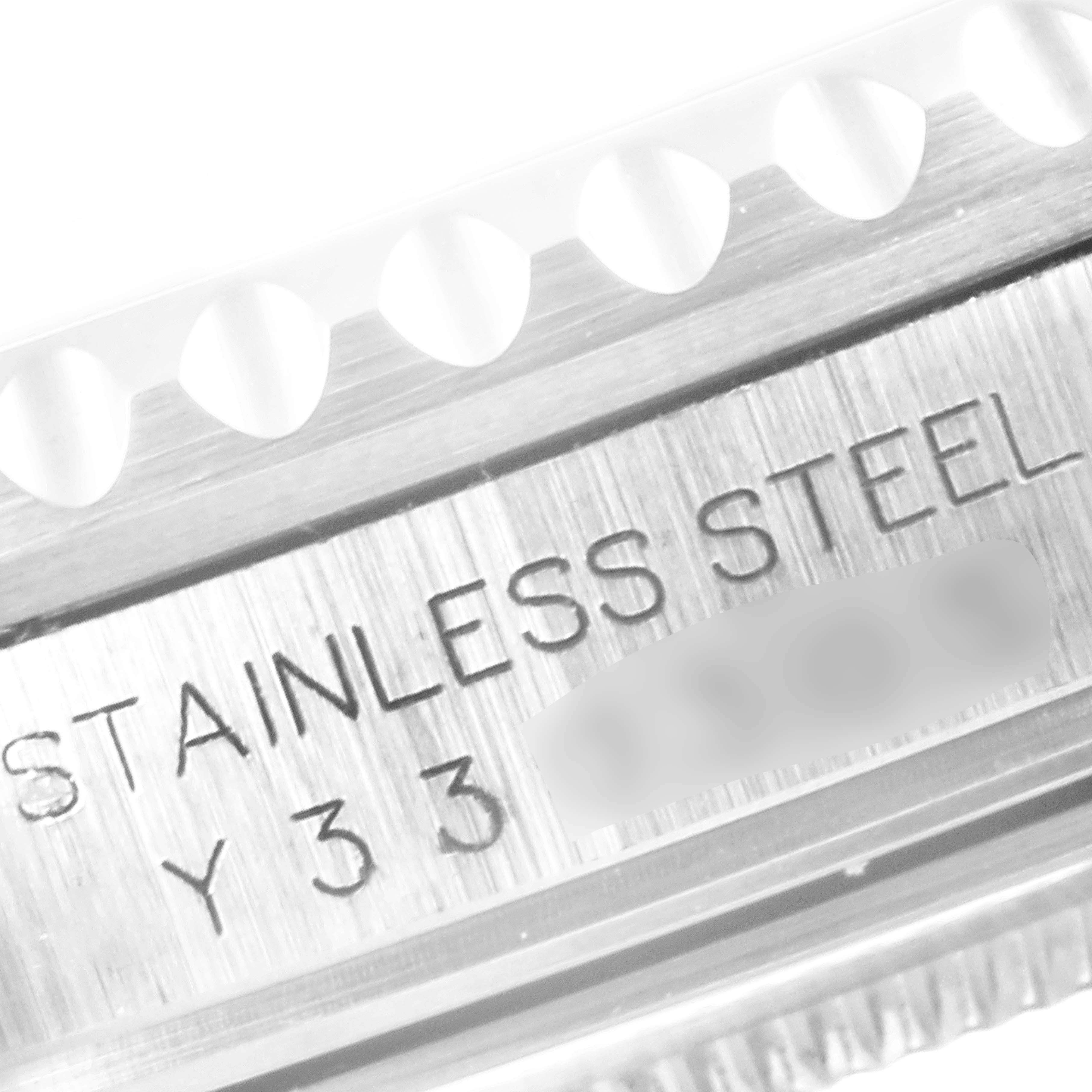 The image shows a close-up of the stainless steel engraving and serrated bezel of a Rolex GMT-Master 16710 Men's Stainless Steel Black Dial 16710 Men's Stainless Steel Black Dial watch.