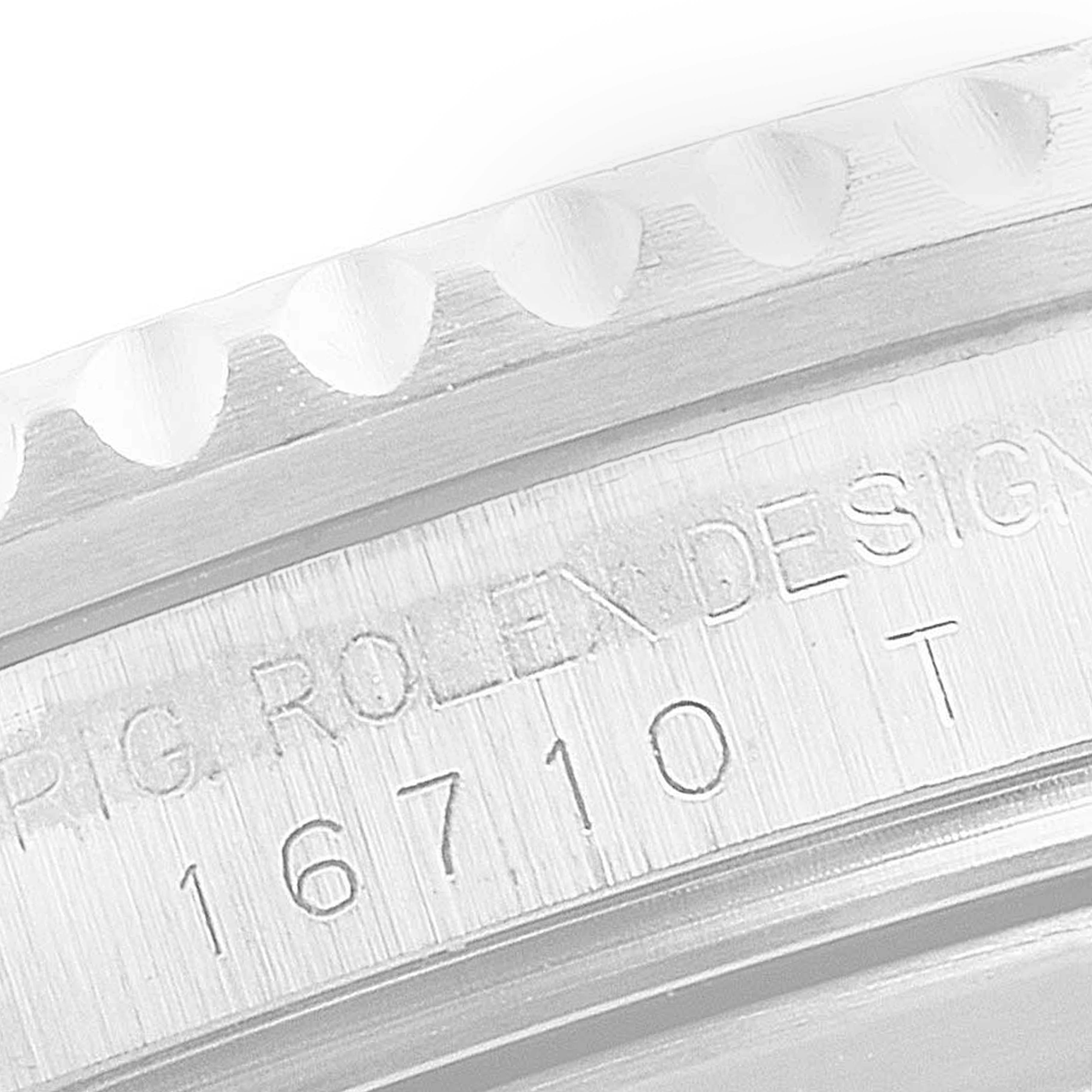 This image shows an engraved case side of a Rolex GMT-Master 16710 Men
s Stainless Steel Black Dial 16710 Men
s Stainless Steel Black Dial model, displaying the reference number and "Rolex Design" text.