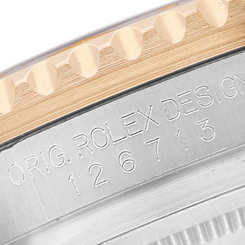 The image shows a close-up of the case side of the Rolex GMT-Master 126713 Men's Stainless Steel Black Dial, highlighting the Model Number engraving and part of the bezel.