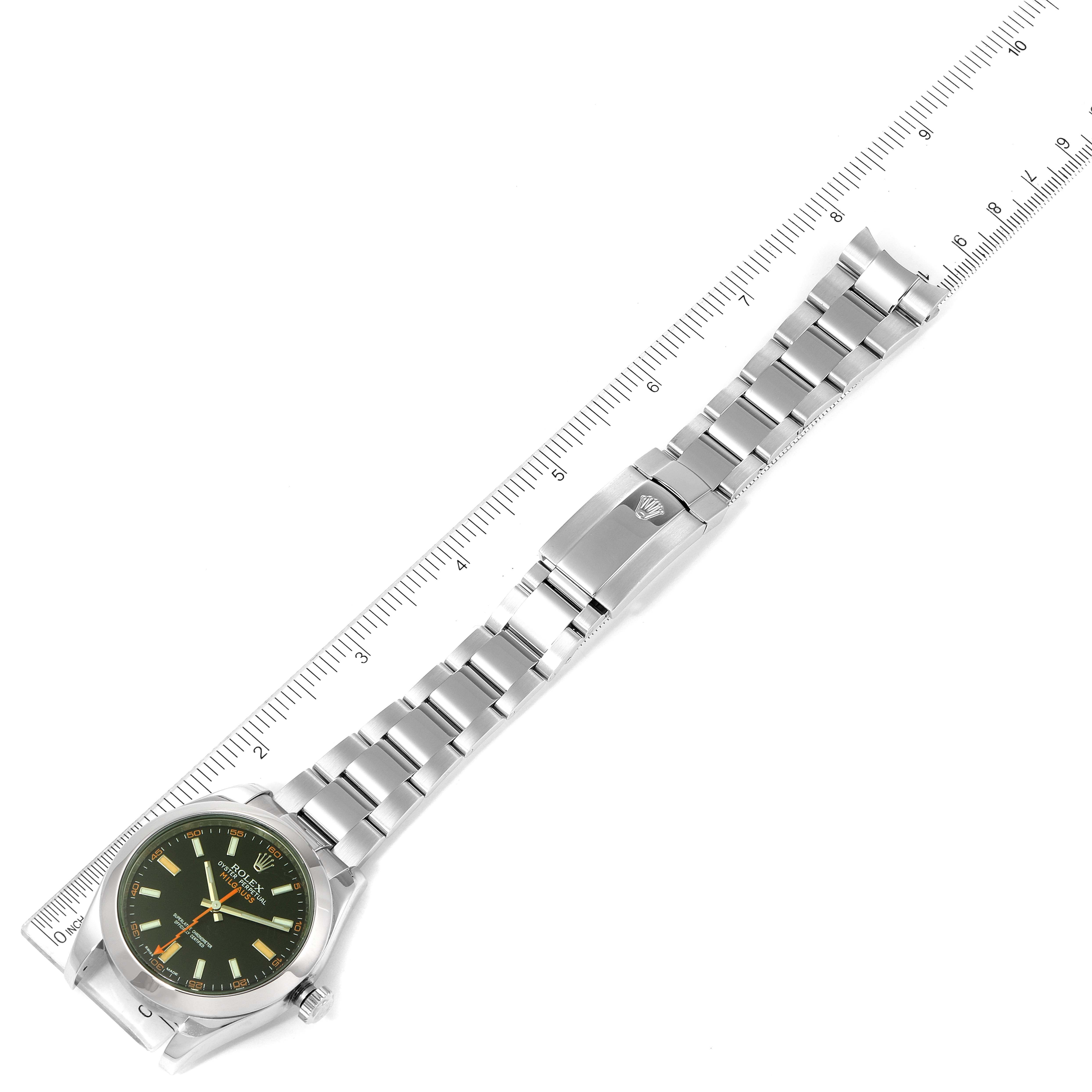 The image shows a Rolex Milgauss 116400GV Men's Stainless Steel Black Dial 116400GV Men's Stainless Steel Black Dial watch laid flat with its face and bracelet, alongside a ruler for size reference.