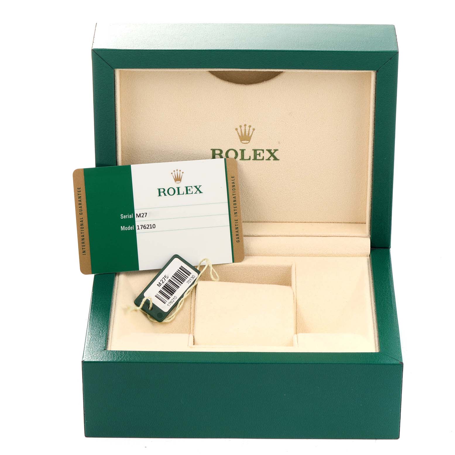 The image shows an open green Rolex box for the Oyster Perpetual model, displaying a guarantee card and a tag.