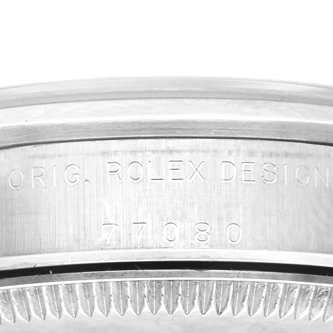 This image shows a close-up of the bezel and case of a Mid-Size Rolex watch, featuring the inscription "ORIG. ROLEX DESIGN" and the model number "77080."