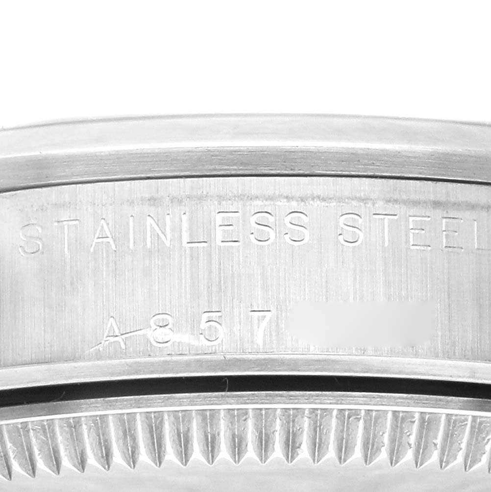 The image shows a close-up of the side of a Mid-Size Rolex watch case with “STAINLESS STEEL” and part of the serial number engraved.