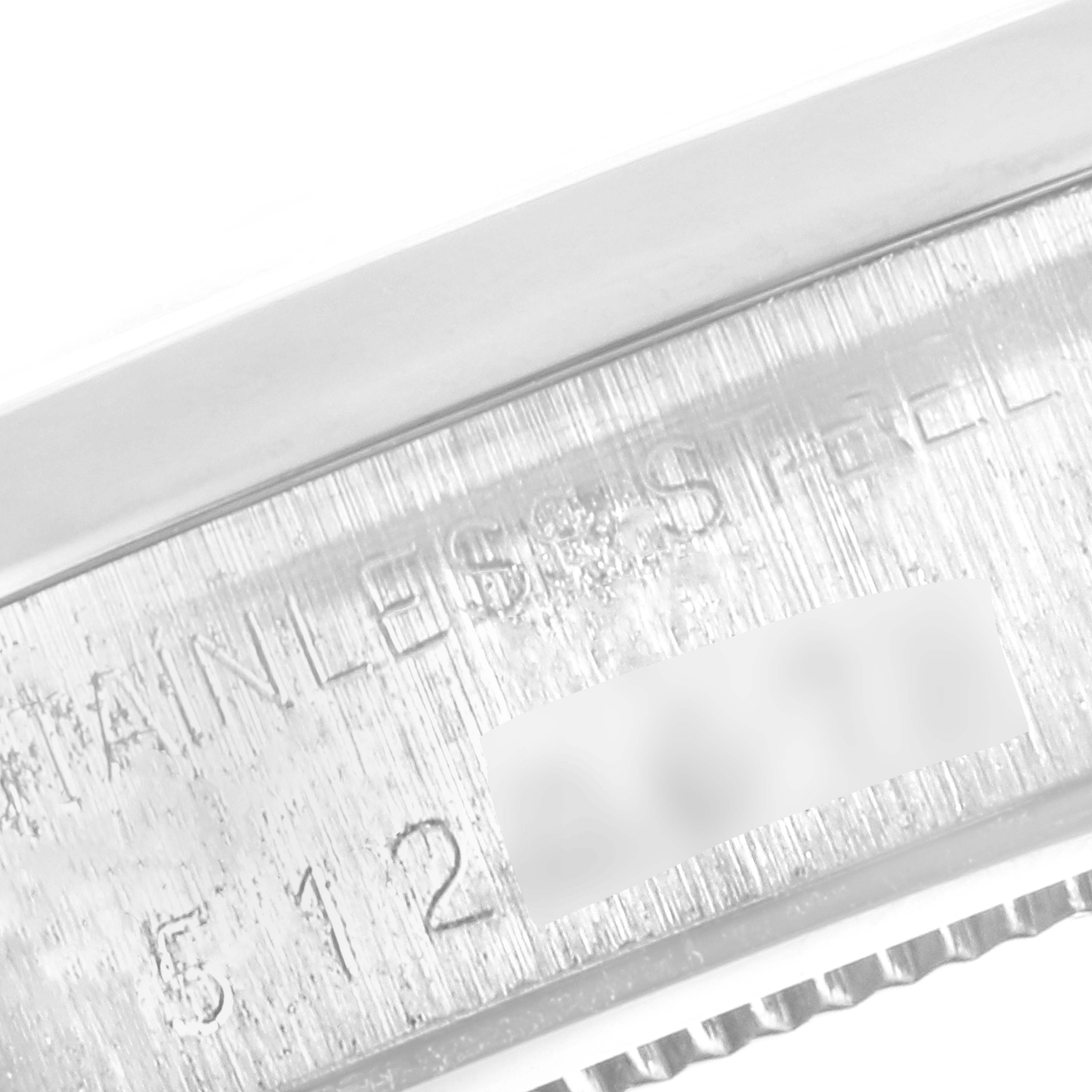 The image displays a close-up of the case side of a Vintage Collection Rolex watch, showing the stainless steel engraving and part of the serial number.