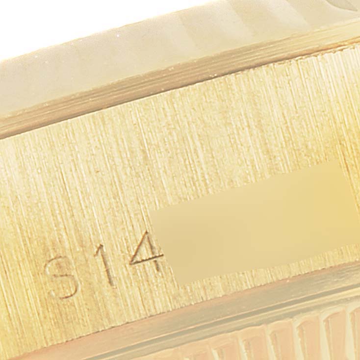 The image shows a close-up angle of the side of a Rolex President 69178 Women
s Yellow Gold Champagne Dial 69178 Women
s Yellow Gold Champagne Dial model watch with visible serial engravings.