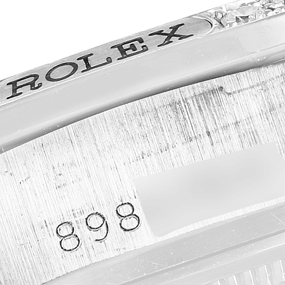 This close-up image shows a part of the Rolex President 18139 Men's White Gold Grey Dial 18139 Men's White Gold Grey Dial model watch, specifically the side of the case with the engraved brand name and serial number.