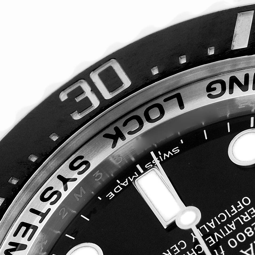 The image shows a close-up of the Rolex Sea-Dweller 116660 Men's Stainless Steel Black Dial's bezel and part of the dial, highlighting the "RING LOCK SYSTEM" and minute markers.