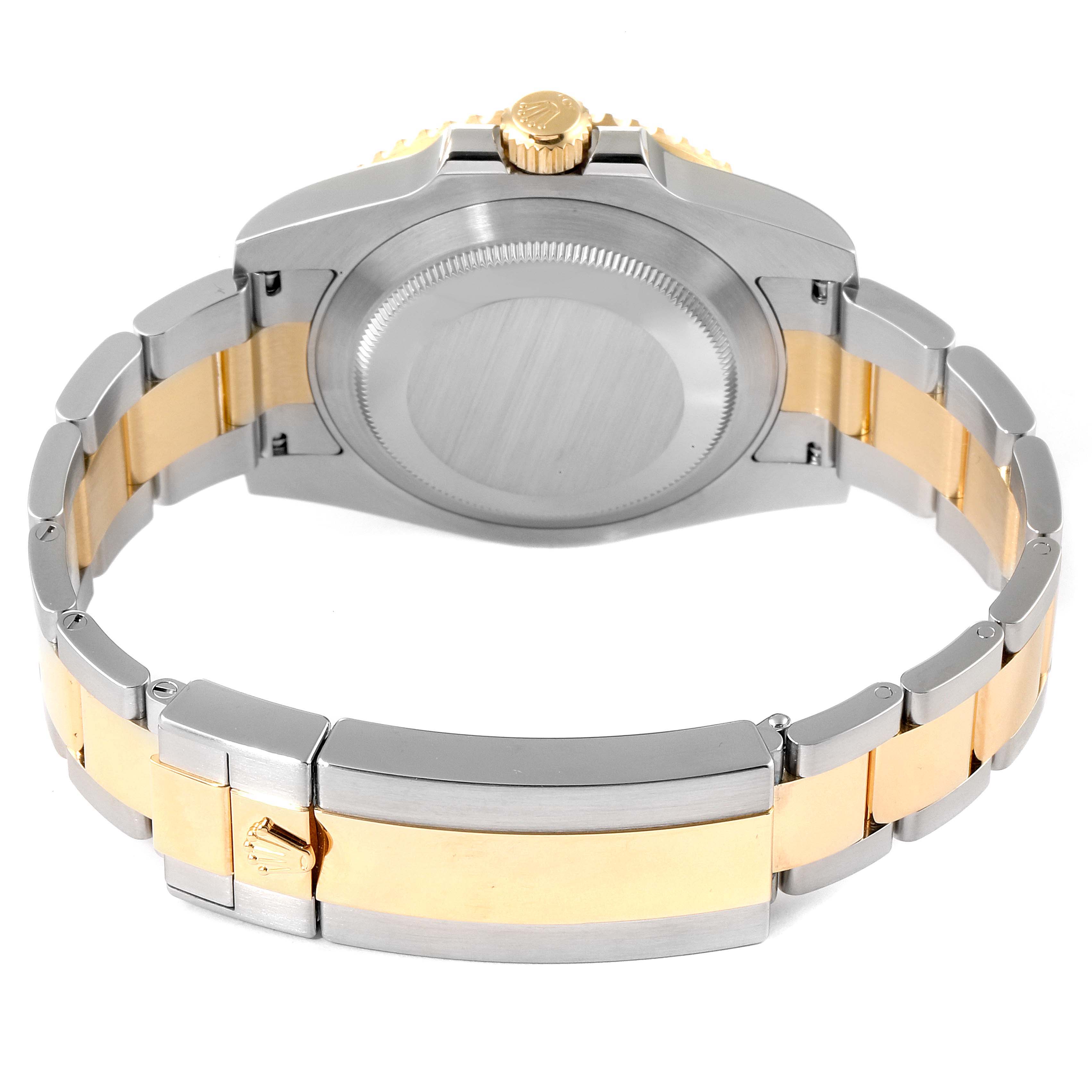 This image shows the back view of a Rolex Submariner 116613 Men
s Steel and Gold (two tone) Black Dial 116613 Men
s Steel and Gold (two tone) Black Dial watch, focusing on its clasp, bracelet, and case back.
