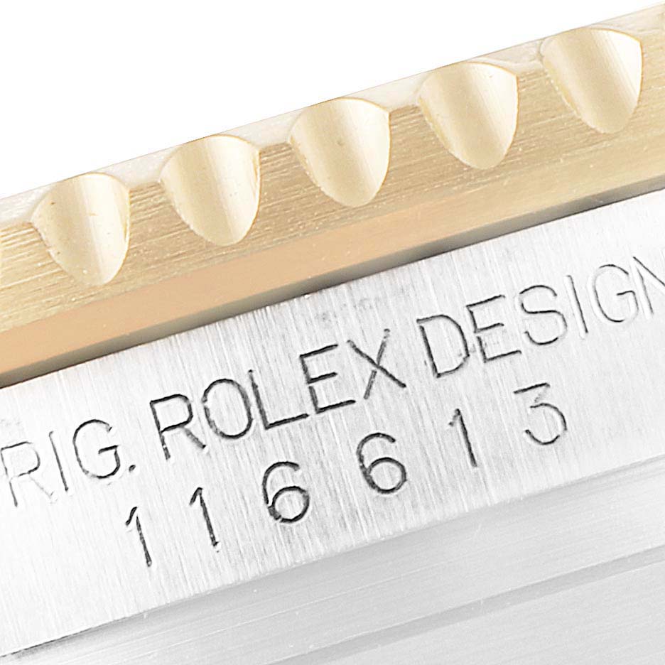This close-up image shows the edge of the bezel and the engraved serial number on a Rolex Submariner 116613 Men
s Steel and Gold (two tone) Black Dial 116613 Men
s Steel and Gold (two tone) Black Dial watch.