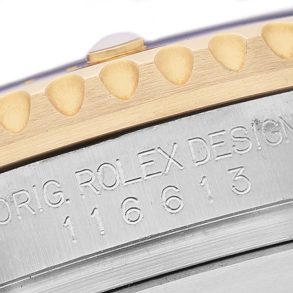 The image shows a close-up of a Rolex Submariner 116613 Men's Steel and Gold (two tone) Blue Dial's bezel edge and engraved case side with model numbers.