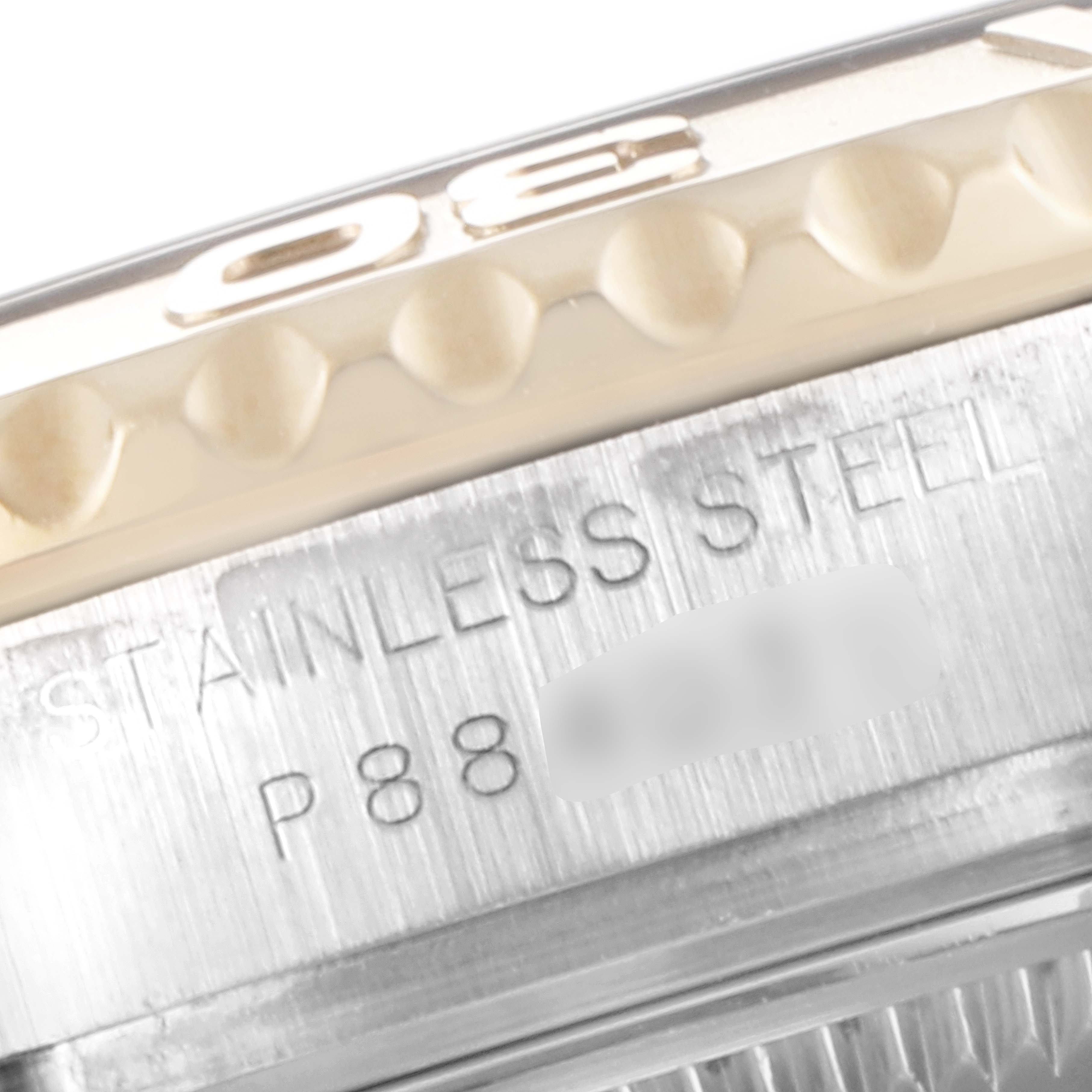 This close-up angle depicts the side of the Rolex Yacht-Master 169623 Women's Steel and Gold (two tone) White Dial 169623 Women's Steel and Gold (two tone) White Dial, showcasing part of the bezel and the engraved stainless steel case.