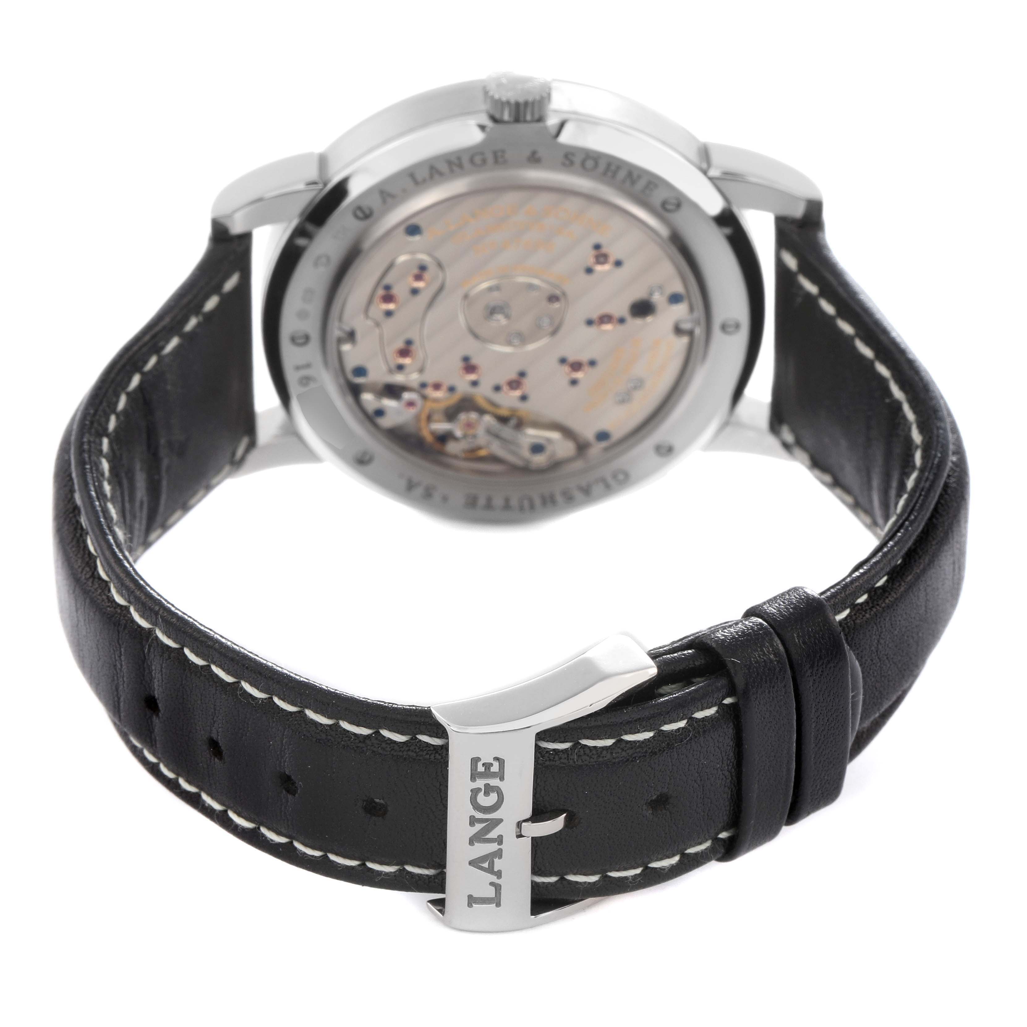 The image shows the back of the A. Lange & Söhne Lange 1 model 115.029, highlighting its movement, leather strap, and buckle.