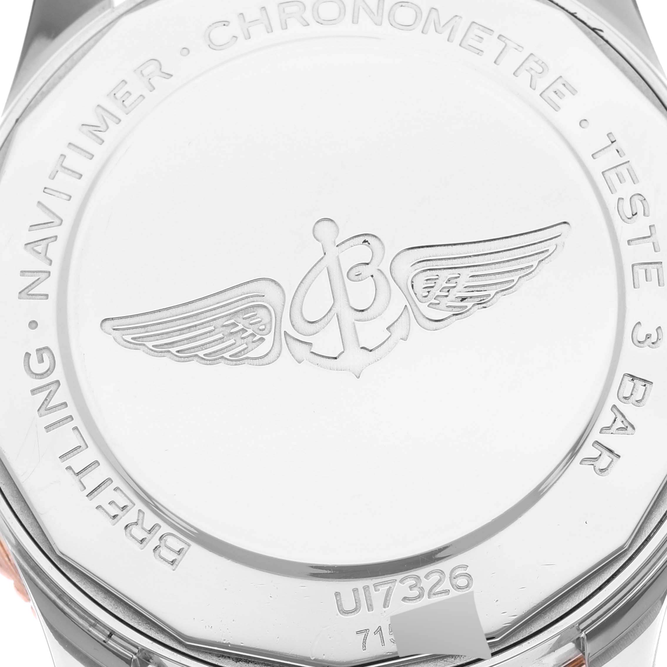 This image shows the case back of a Breitling Navitimer U17326 Men
s Stainless Steel Grey Dial U17326 Men
s Stainless Steel Grey Dial watch, featuring an engraved logo and various inscriptions.