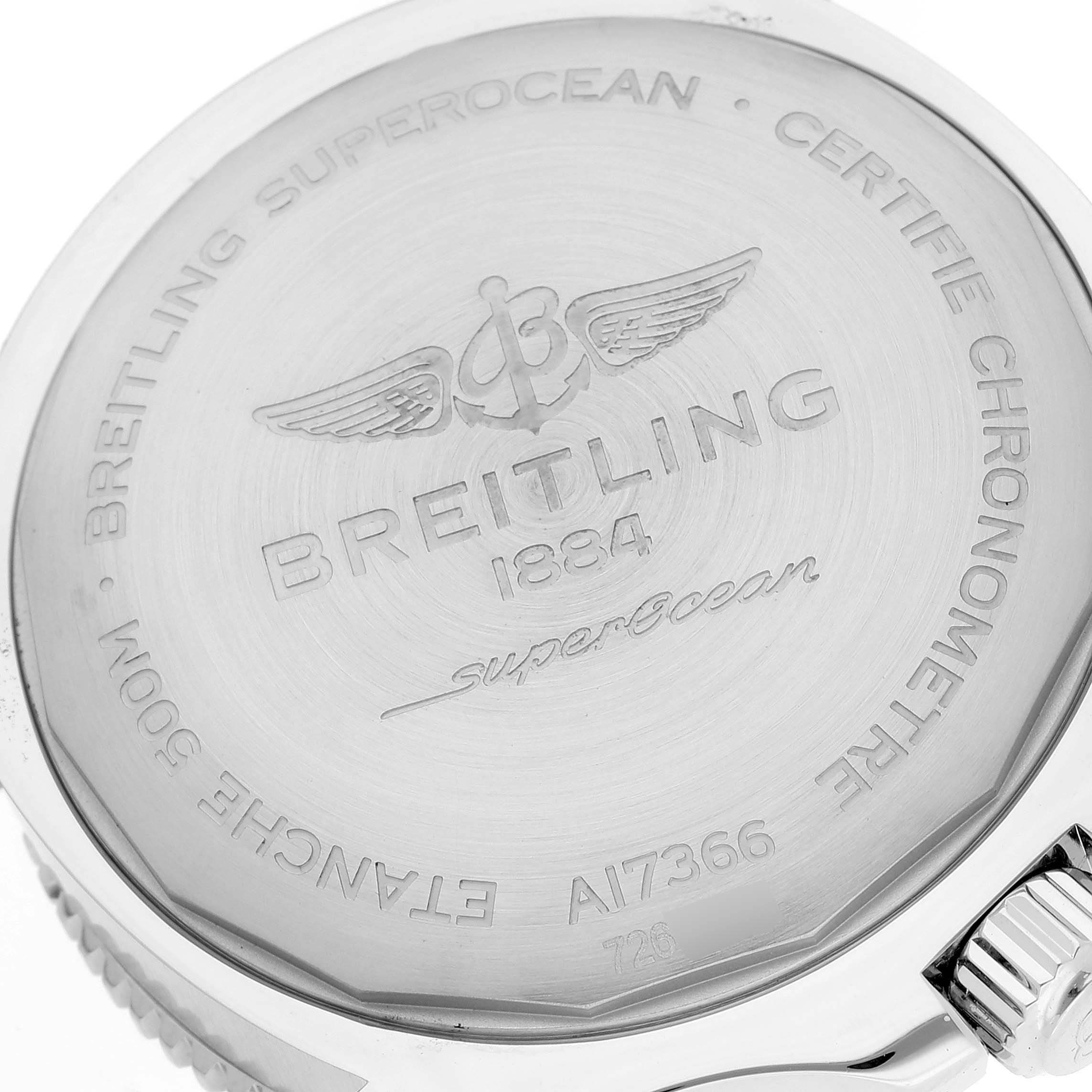 This image shows the back case of the Breitling Superocean A17366 Men's Stainless Steel White Dial A17366 Men's Stainless Steel White Dial watch from an overhead angle, highlighting its engravings.