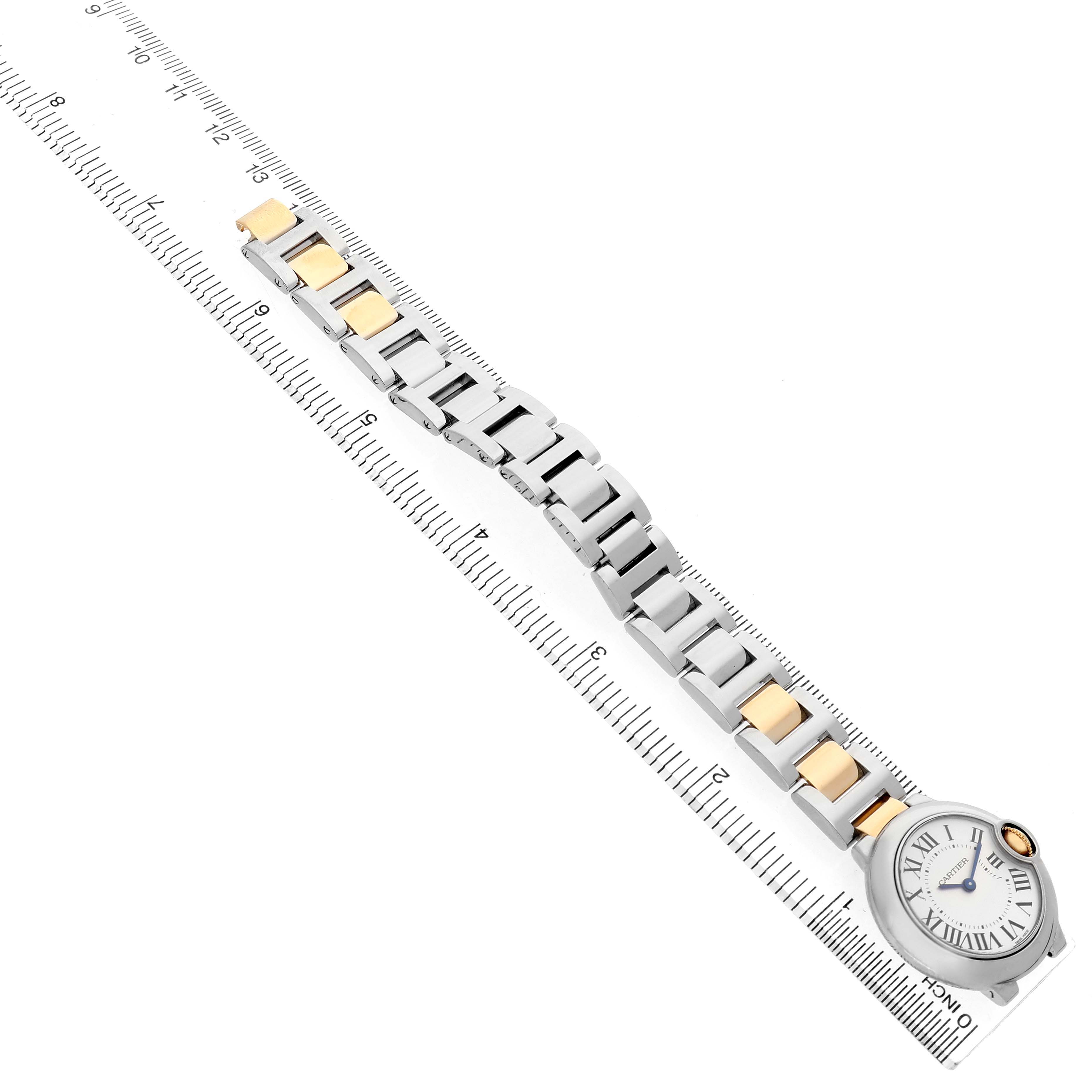 The Cartier Ballon Bleu W69007Z3 Women's Steel and Gold (two tone) Silver Dial watch is shown from a top angle, displaying the face and entire metal bracelet alongside a ruler.